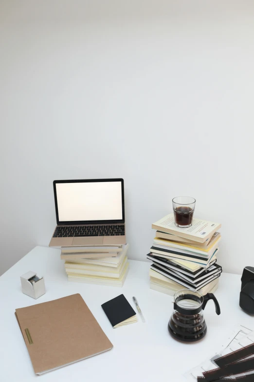 a laptop computer sitting on top of a white table, by Carey Morris, holding books, objects, multiple stories, multiple levels