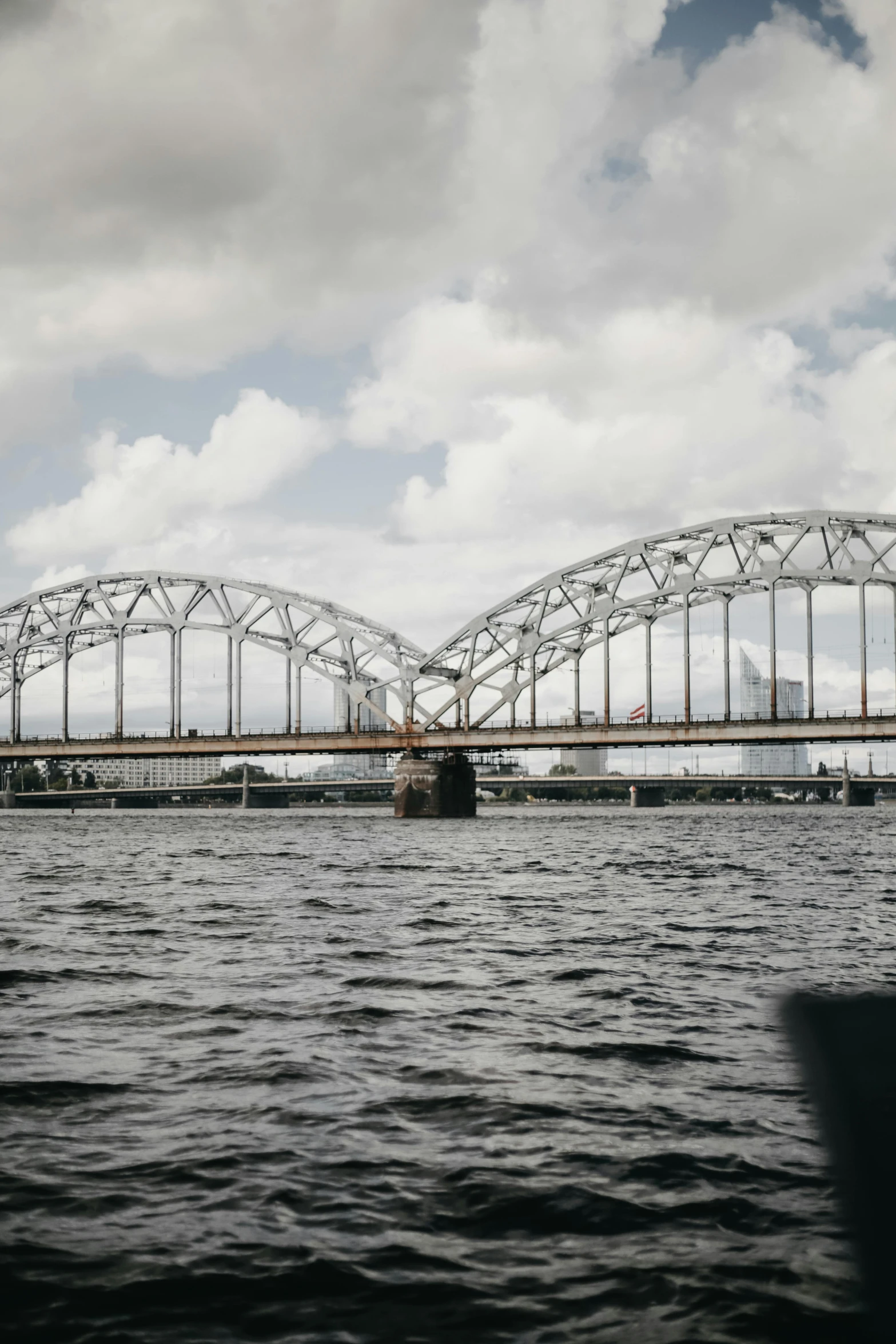 a bridge over a body of water under a cloudy sky, pexels contest winner, art nouveau, peter the great, white sweeping arches, high quality photo, calcutta