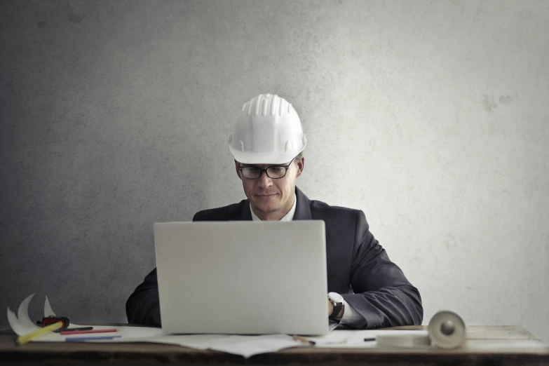 a man in a hard hat working on a laptop, pexels contest winner, renaissance, wearing a suit and glasses, steel and metal, no - text no - logo, profile image