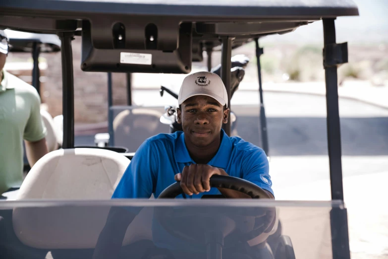 a man sitting in the driver's seat of a golf cart, a portrait, unsplash, black man, avatar image, high resolution photo, working hard