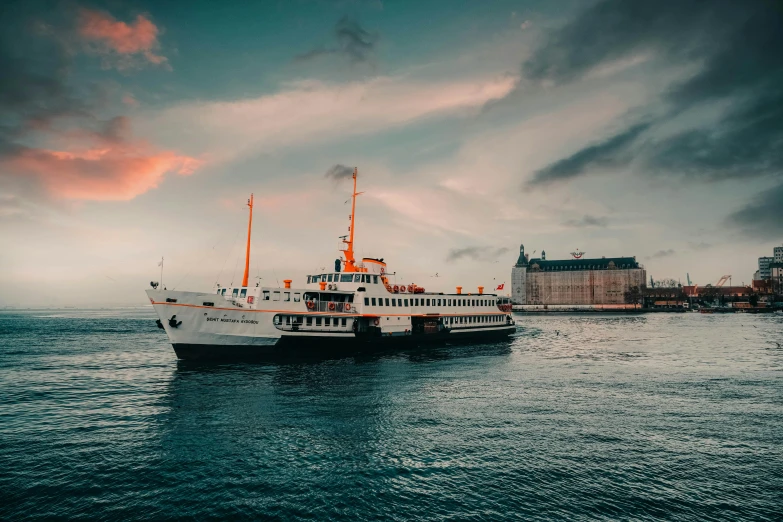 a large boat floating on top of a body of water, by Jesper Knudsen, pexels contest winner, art nouveau, sea ground, evening time, lightroom preset, 🚿🗝📝