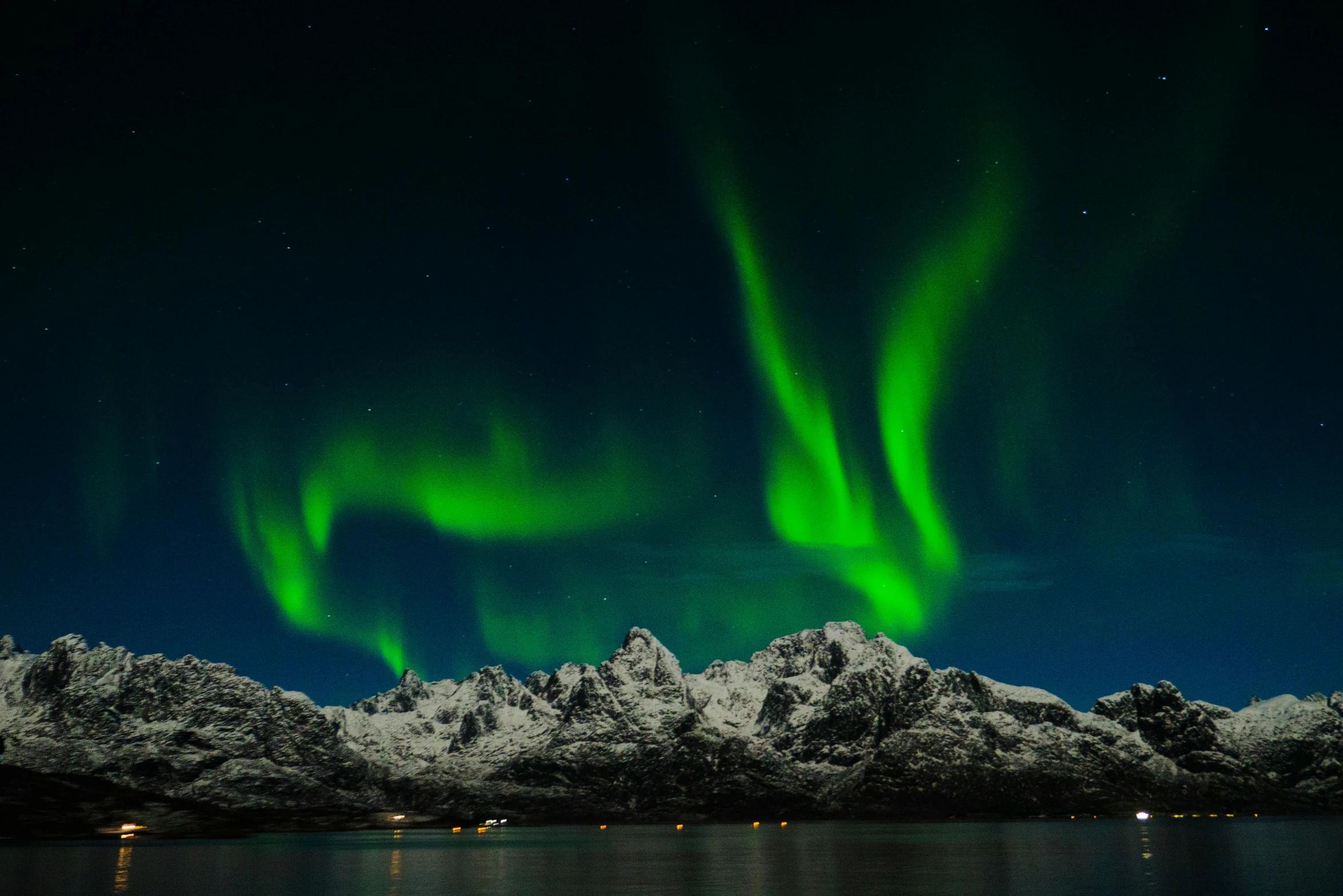 a large body of water with snow covered mountains in the background, by Julia Pishtar, pexels contest winner, hurufiyya, glowing green lights, nordic crown, threyda, national geographic ”