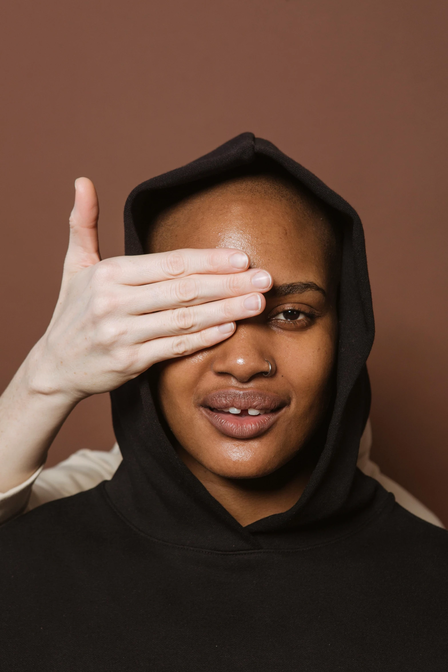 a woman covering her eyes with her hands, an album cover, by Cosmo Alexander, trending on pexels, an epic non - binary model, hand on his cheek, blind brown man, default pose neutral expression