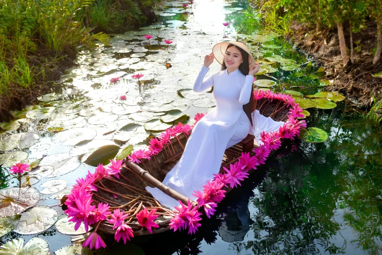 a woman in a white dress is sitting in a boat, ao dai, avatar image, paradise garden massage, pink lotus queen