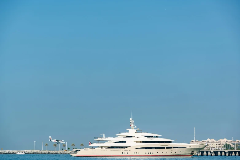 a large white boat floating on top of a body of water, by Gavin Hamilton, pexels contest winner, renaissance, on a super yacht, long beach background, 2 5 6 x 2 5 6 pixels, side view from afar