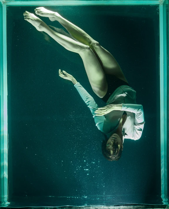 a woman floating in a glass box in the water, inspired by Elsa Bleda, unsplash contest winner, olympic diving springoard, promo image, concert photo, very terrifying