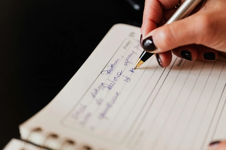 a person writing on a notebook with a pen, by Julia Pishtar, essence, thumbnail, closeup, customers