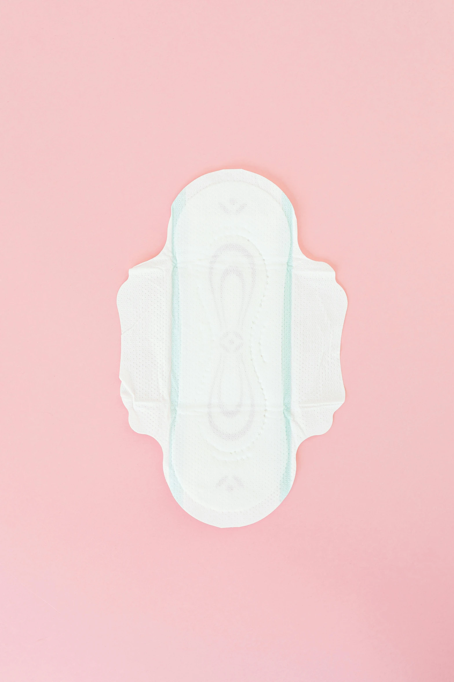 a baby diaper sitting on top of a pink surface, cartouche, feminine shapes, on clear background, instagram post