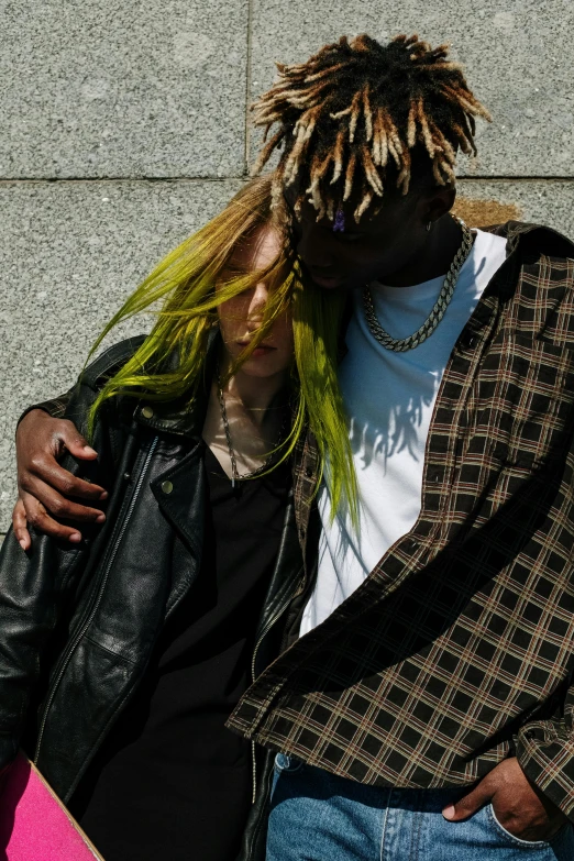 a man standing next to a woman holding a skateboard, inspired by Elsa Bleda, trending on pexels, renaissance, green feathery hair, black and yellow, a man wearing a black jacket, dreads