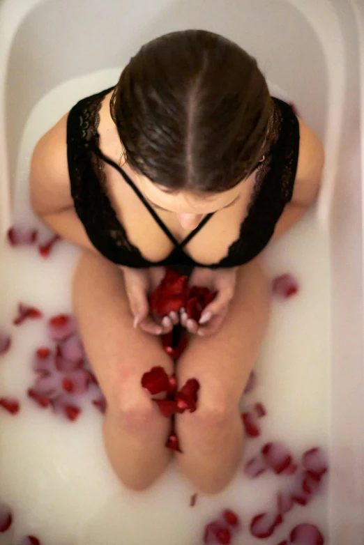 a woman sitting in a bath tub filled with rose petals, self erotic, candy treatments, brooke ashling, pouring