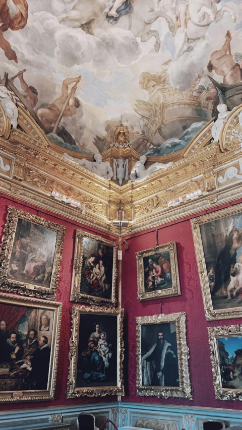 a room with a lot of paintings on the walls, inspired by Domenico Quaglio the Younger, rococo, tall ceiling, photographs, golden detailing, payne's grey and venetian red