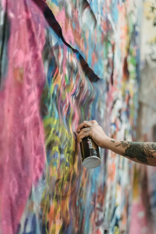 a man spray painting graffiti on a wall, trending on pexels, lush, tattooed, courtesy of moma, clayton crain