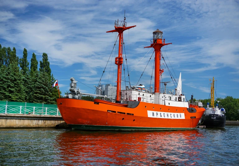 a large orange boat sitting on top of a body of water, a photo, in russia, one piece ship sailing, hyacinthe rigaurd, adventure