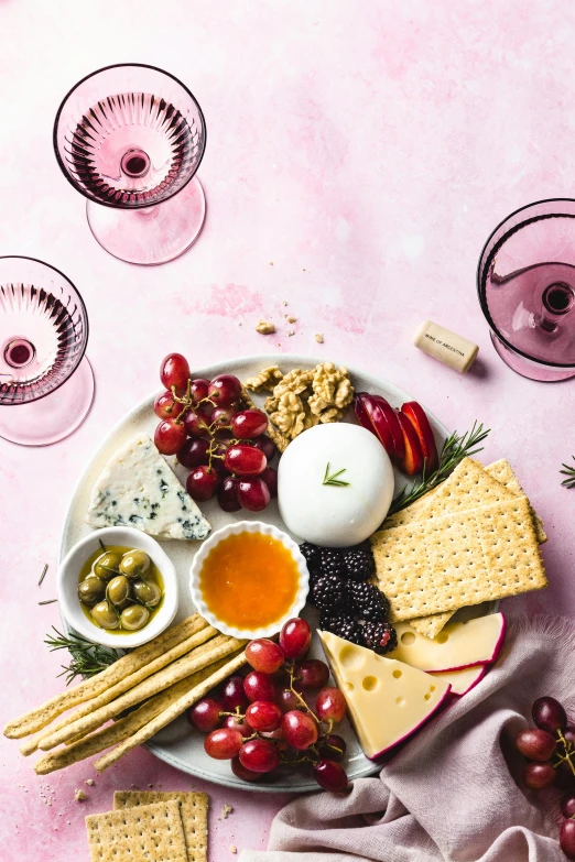 a plate of cheese, crackers, grapes and olives, a still life, pexels, pink and red color scheme, bubbly, mozzarella, magenta