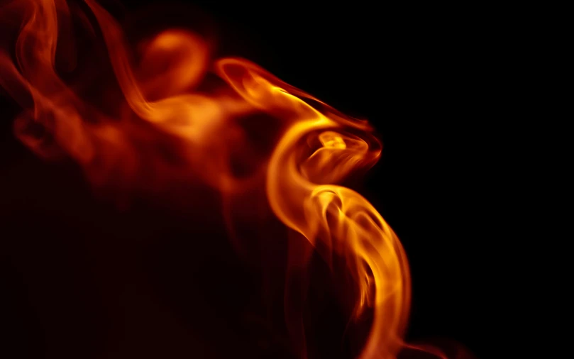 a close up of a fire on a black background, by Daniel Lieske, pexels, digital art, avatar image, from the side, swoosh, fiery red