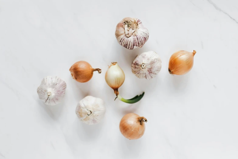 a bunch of onions and garlic on a table, by Kristin Nelson, trending on unsplash, on a large marble wall, transparent background, group of seven, silver，ivory
