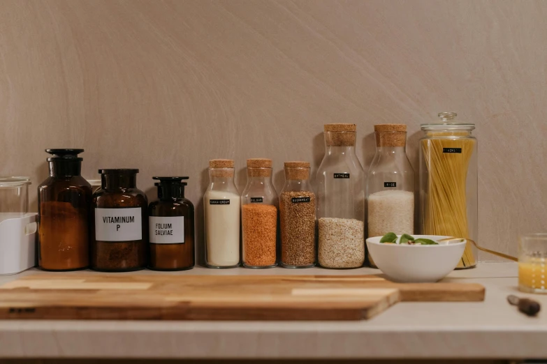 a wooden cutting board sitting on top of a counter, a picture, jars, detailed product image, small scale, detail shot