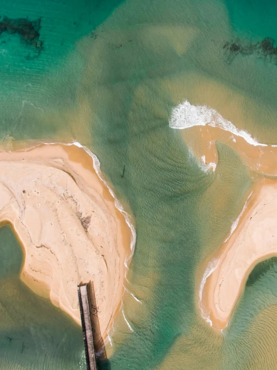 an aerial view of a bridge over a body of water, by Daniel Taylor, pexels contest winner, conceptual art, sandy colours, australian beach, thumbnail, two medium sized islands