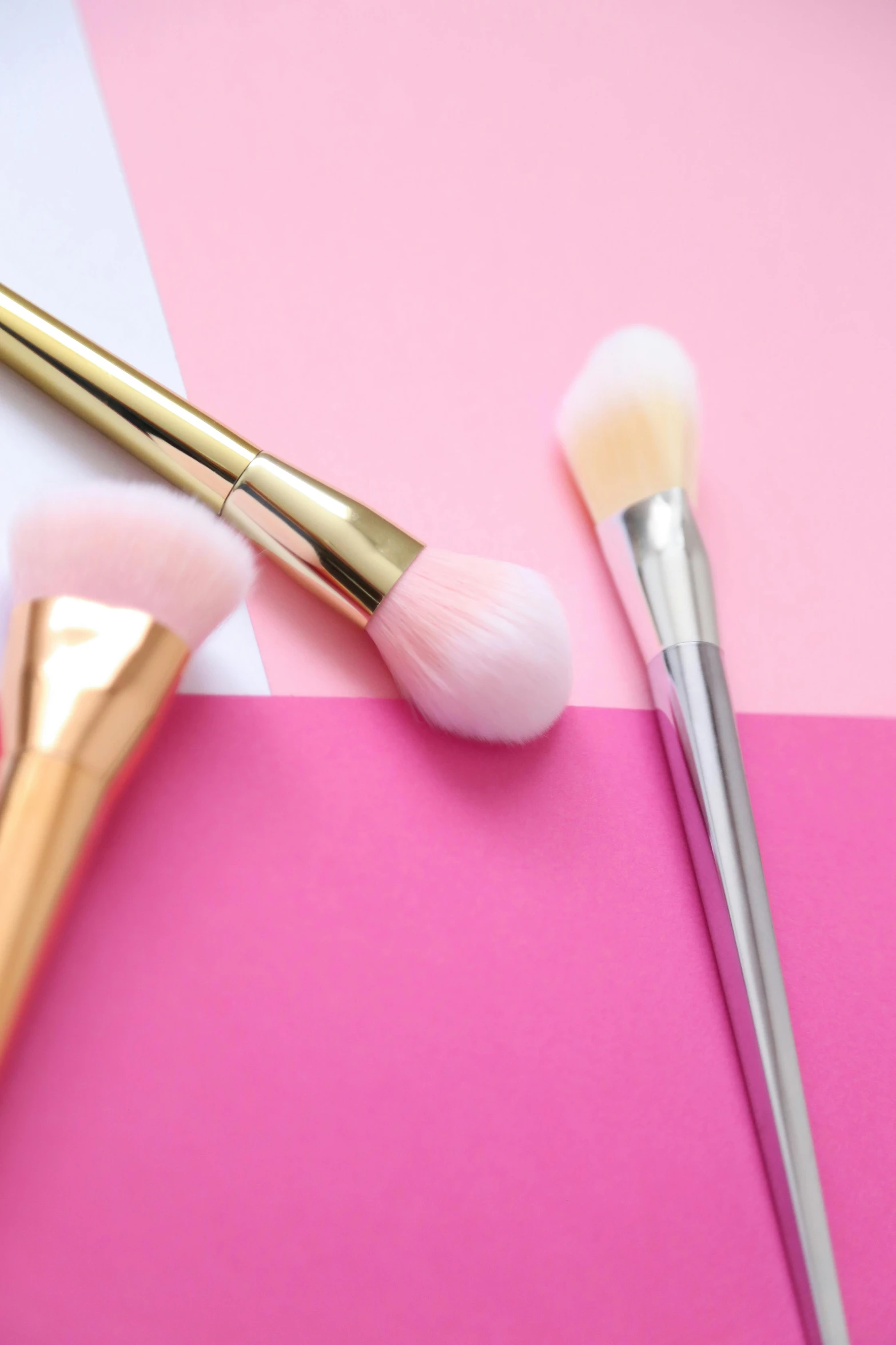 a couple of brushes sitting on top of a pink and white surface, gradient white to gold, pastel makeup, detailed product image, catwalk