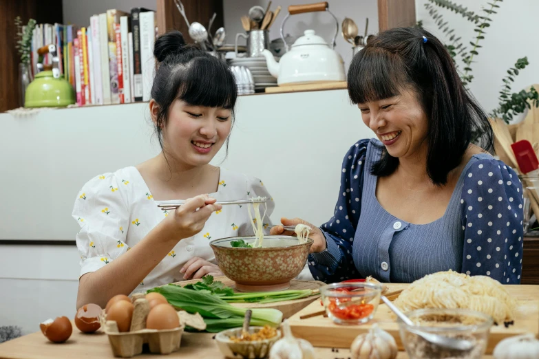two women sitting at a table with a bowl of food, inspired by Tan Ting-pho, pexels contest winner, cooking oil, avatar image, family, joy ang