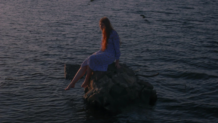 a woman sitting on a rock in the water, an album cover, inspired by Elsa Bleda, pexels contest winner, renaissance, early evening, low quality footage, on the sea, portrait shot 8 k