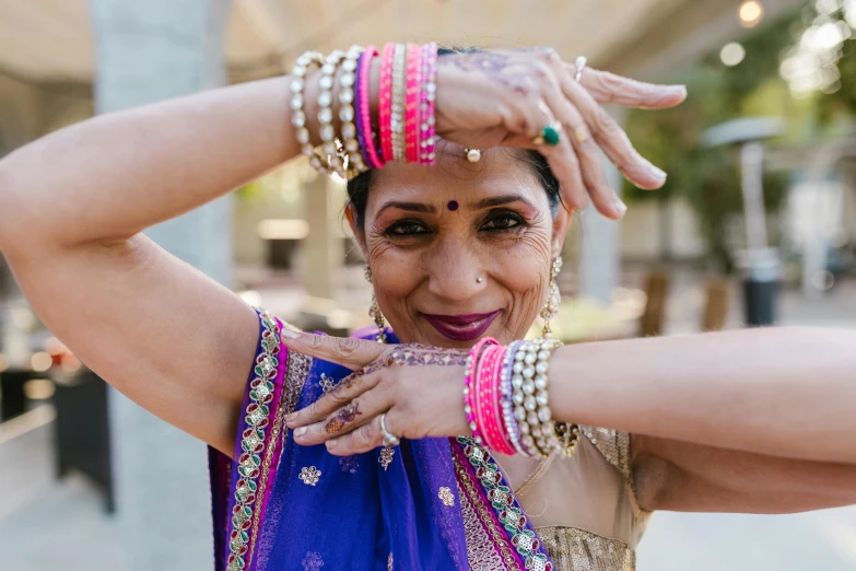 a woman in a sari poses for a picture, by Natasha Tan, trending on unsplash, renaissance, wearing two silver bracelets, 5 5 yo, wearing festive clothing, dance