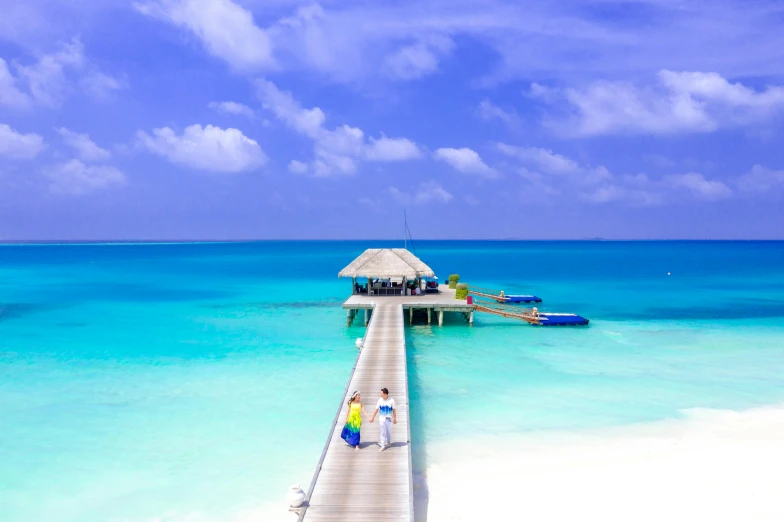 a pier in the middle of a body of water, pexels contest winner, hurufiyya, beautiful tropical island beach, people walking around, cyan colors, listing image