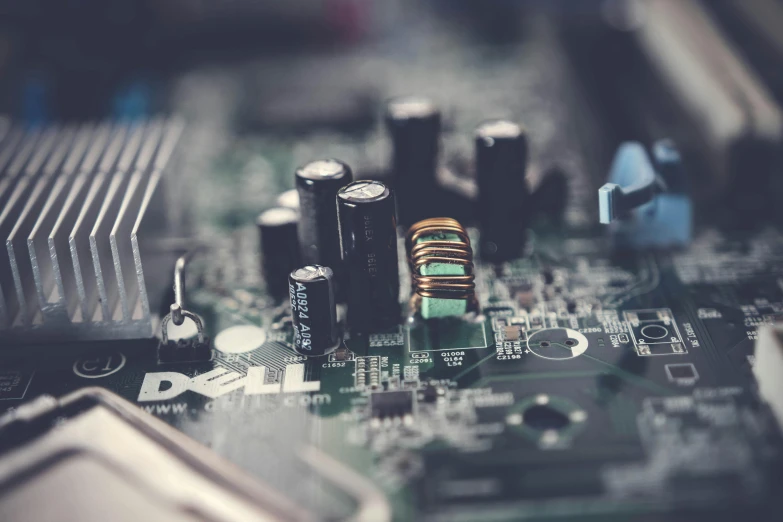 a close up of a computer mother board, by David Donaldson, pexels, instagram post, battery and wires, desaturated, built on a small