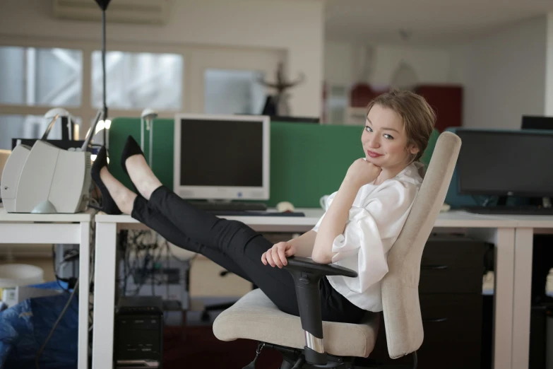 a woman sitting in a chair in an office, pexels contest winner, pretty face with arms and legs, avatar image, lachlan bailey, pale - skinned