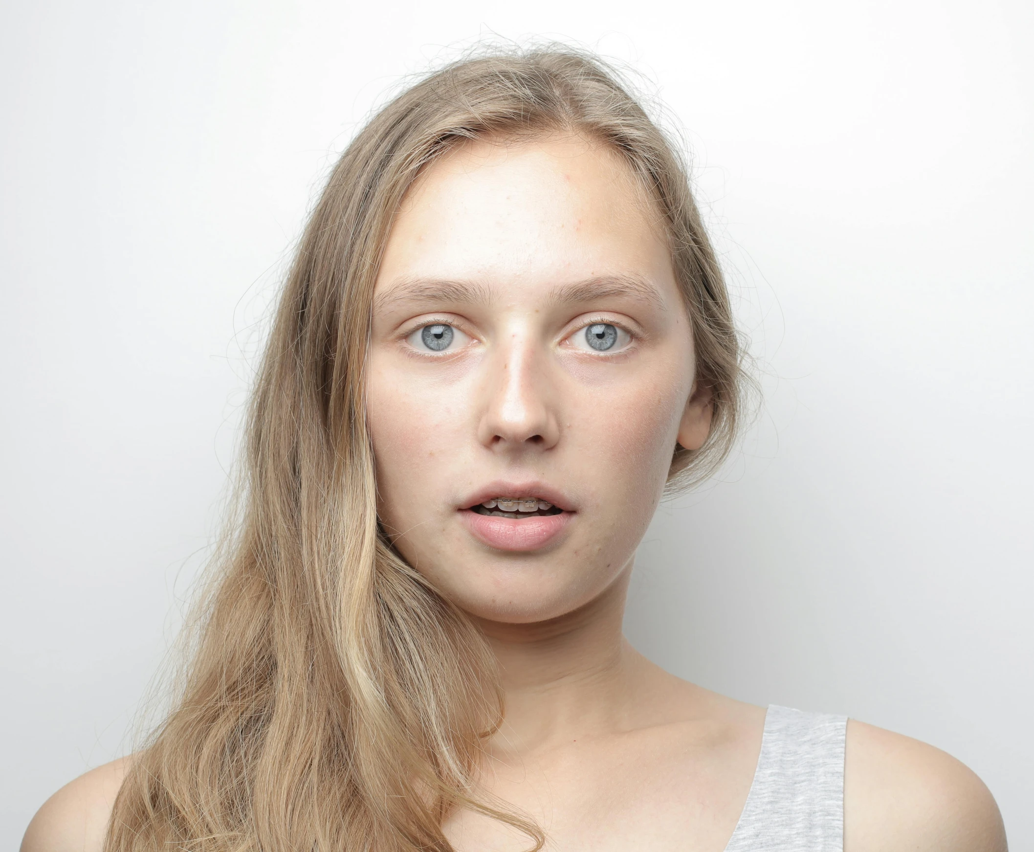 a close up of a person with long hair, inspired by Louisa Matthíasdóttir, unsplash, hyperrealism, passport photo, her skin is light brown, pale bluish skin, ready to model