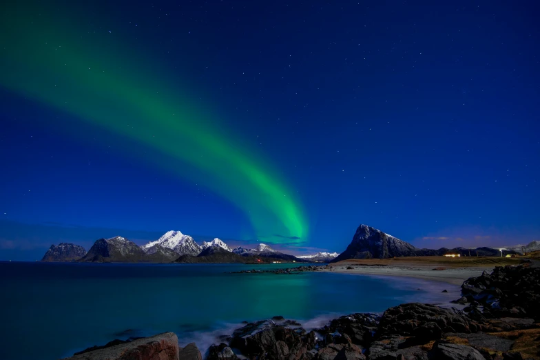 a large body of water with mountains in the background, by Julia Pishtar, pexels contest winner, hurufiyya, northen lights background, coastal, blue and green light, a colorful