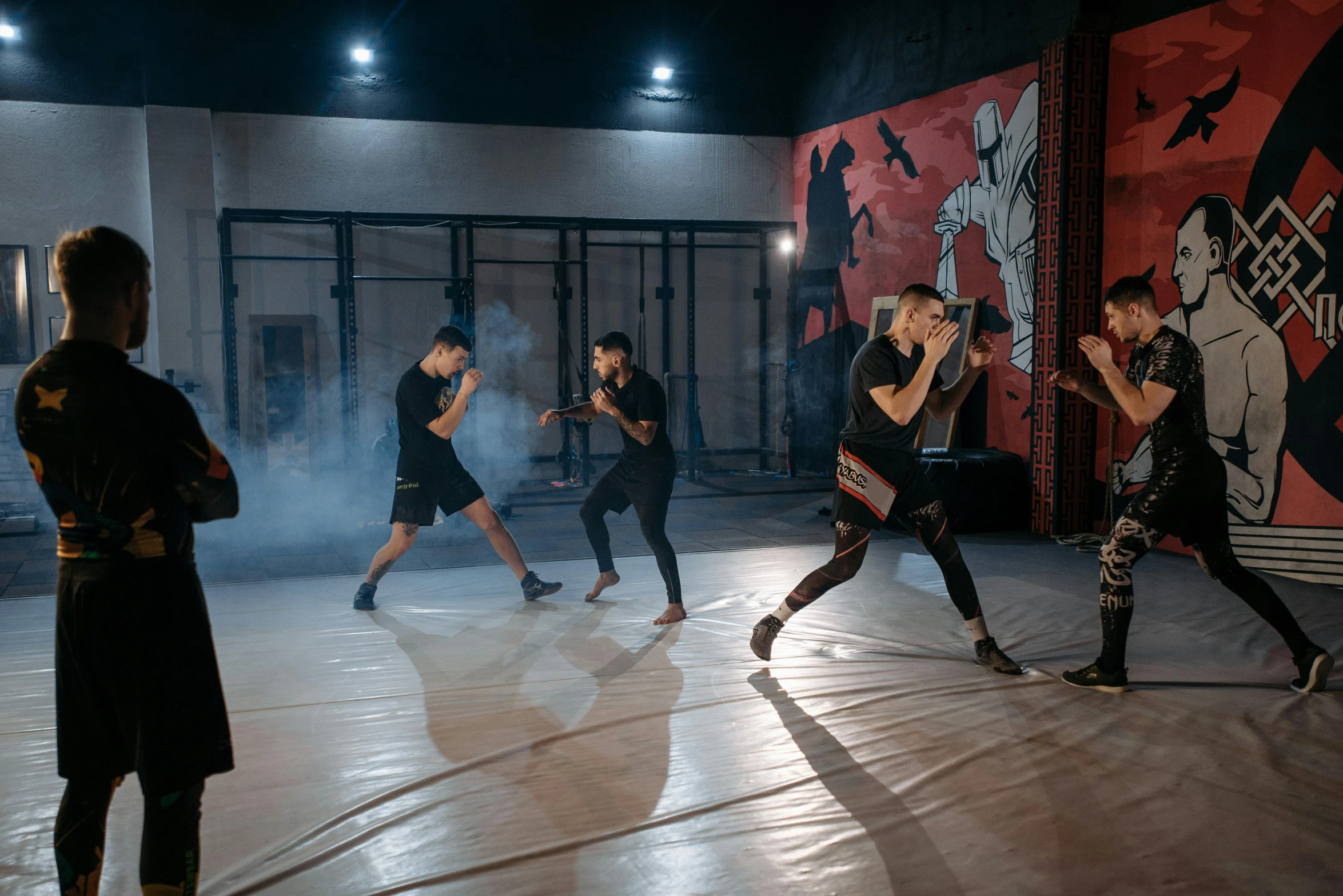 a group of people standing on top of a dance floor, mma southpaw stance, background image, [ theatrical ], indoor picture