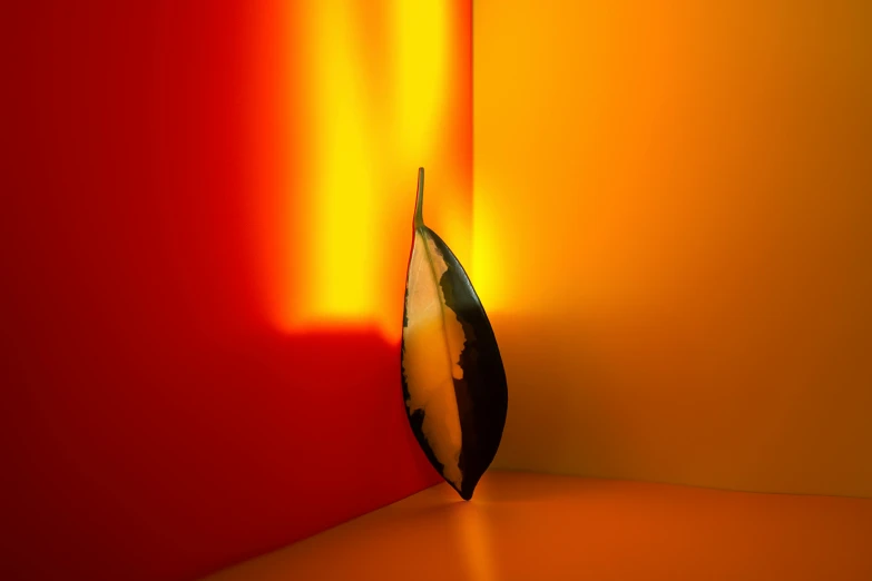 a close up of a knife on a table, an abstract sculpture, inspired by Man Ray, unsplash contest winner, lyrical abstraction, red and yellow light, rgb wall light, ( ( ( ( 3 d render ) ) ) ), flaming leaves