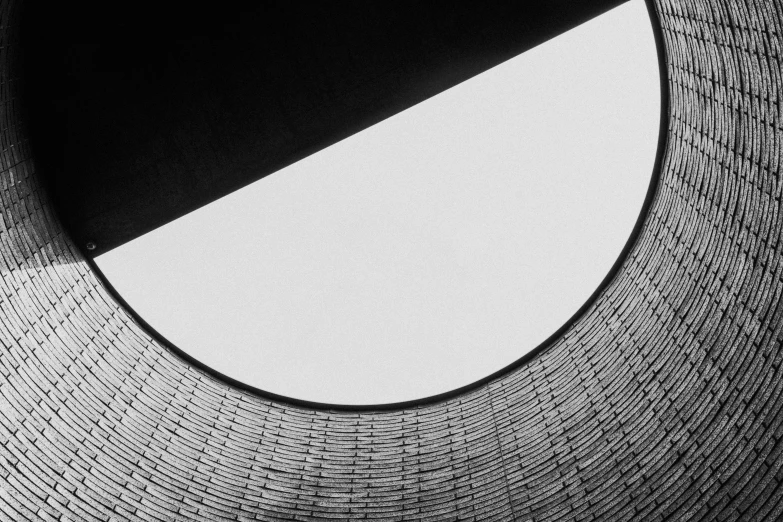 a black and white photo of a circular window, by Karl Buesgen, unsplash, minimalism, oscar niemeyer, intricate detailed roof, half moon, abstract high quality