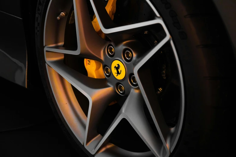 a close up of a wheel on a sports car, a digital rendering, pexels contest winner, photorealism, yellow artificial lighting, ferrari 458, detail studio quality lighting, side lights