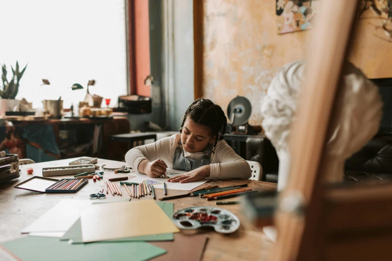 a little girl that is sitting at a table, a child's drawing, by Lee Loughridge, pexels contest winner, people at work, cardboard, indigenous art, elegant study