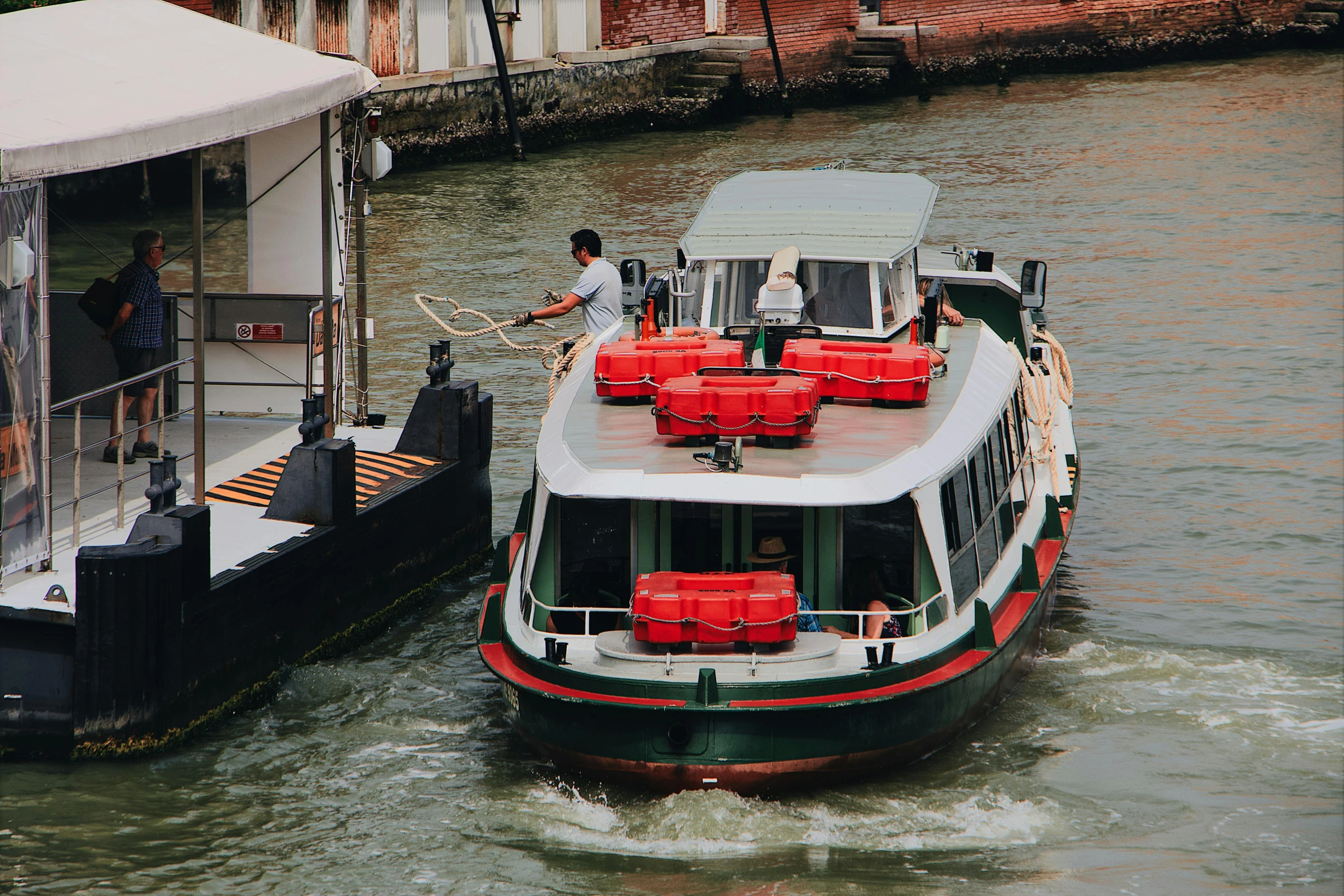 a couple of boats that are in the water, pexels contest winner, olive green and venetian red, 🚿🗝📝, venice biennale, utilitarian cargo ship