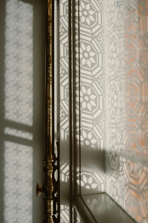 a mirror sitting on top of a wall next to a window, a silk screen, inspired by Riad Beyrouti, baroque, close up subtle shadows, subtle pattern, shafts of light, demur