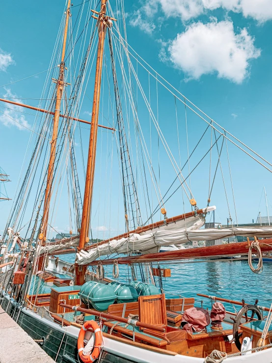 a boat that is sitting in the water, on the deck of a sailing ship, 🚿🗝📝, picton blue, thumbnail