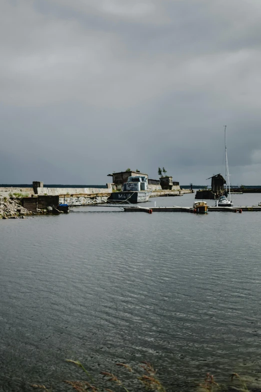 a body of water with a bunch of boats in it, reykjavik, ruins, military base, low quality photo