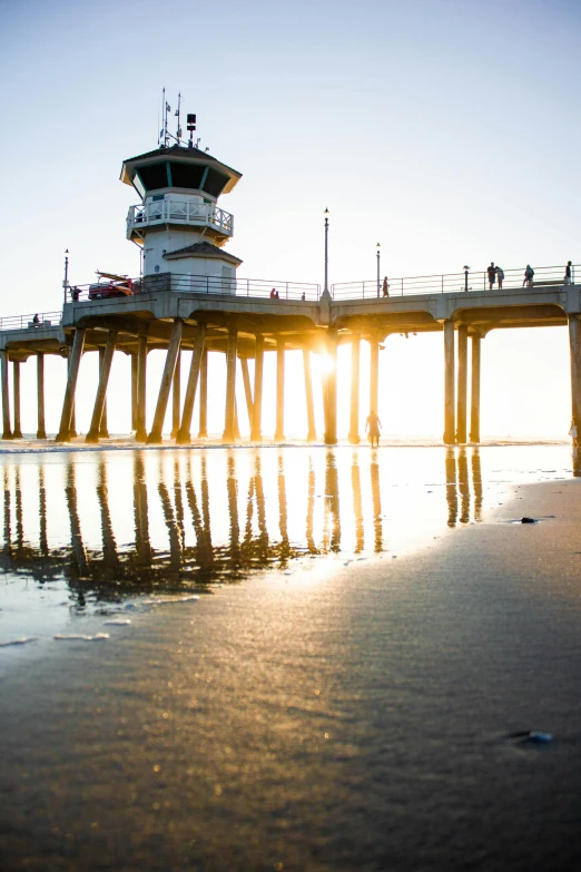 a man riding a skateboard on top of a sandy beach, by Jacob Burck, unsplash contest winner, water reflecting suns light, lighthouse, pch, # nofilter