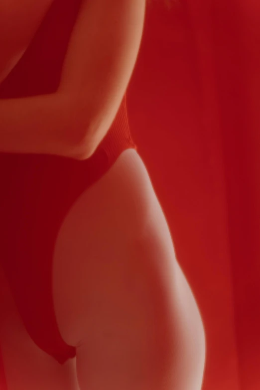 a close up of a woman in a red bathing suit, inspired by Nan Goldin, unsplash, figurative art, horst p. horst, shaped derriere, gif, david kassan