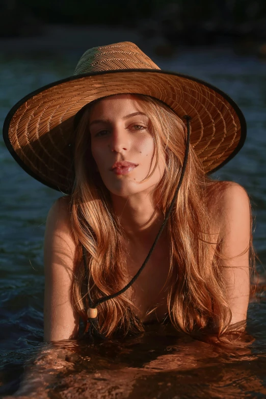 a woman sitting in the water wearing a hat, an album cover, inspired by Elsa Bleda, unsplash, renaissance, woman looks like sharon tate, wearing straw hat, amber heard, neck zoomed in from lips down