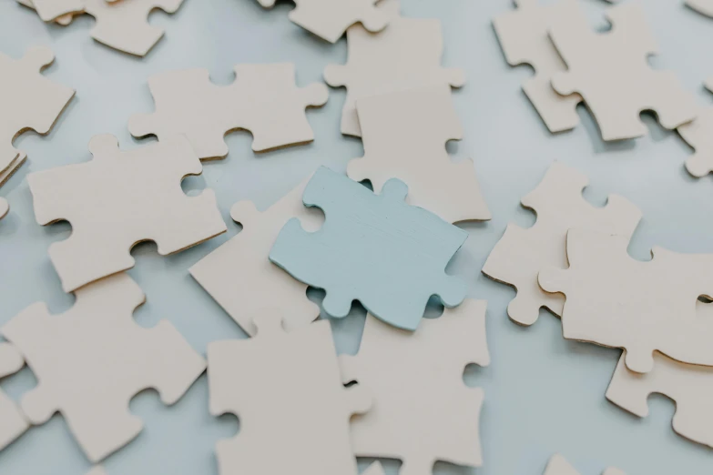 a blue piece of puzzle sitting on top of a pile of white puzzle pieces, trending on unsplash, background image, instagram post, elliot alderson, white and pale blue