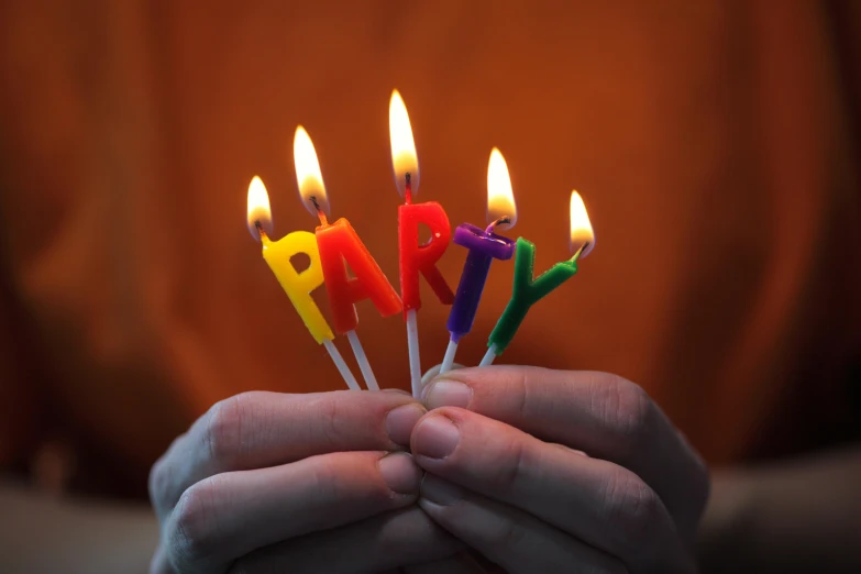 a person holding a bunch of birthday candles, by Dan Content, pexels, escherichia coli party, avatar image, gay rights, paul davey