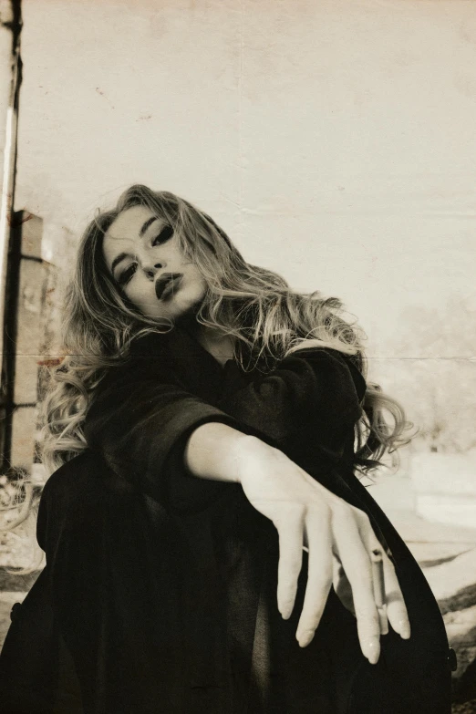 a black and white photo of a woman sitting on a bed, an album cover, trending on pexels, renaissance, amber heard, 90's color photo, concert, handsome girl