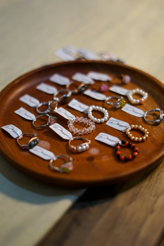 a brown plate sitting on top of a wooden table, jewelry display, hair loops, shot with sony alpha, various styles