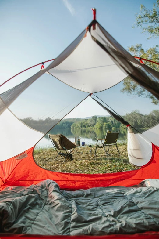 the inside of a tent with a view of a lake, soft grey and red natural light, adventure gear, college, full product shot