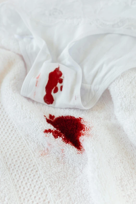 a white shirt with a blood stain on it, trending on pexels, red robe, towels, blooded, head down