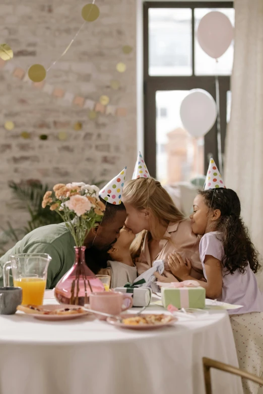 a man kissing a little girl at a birthday party, pexels contest winner, figuration libre, group sit at table, promo image, cute woman, at home